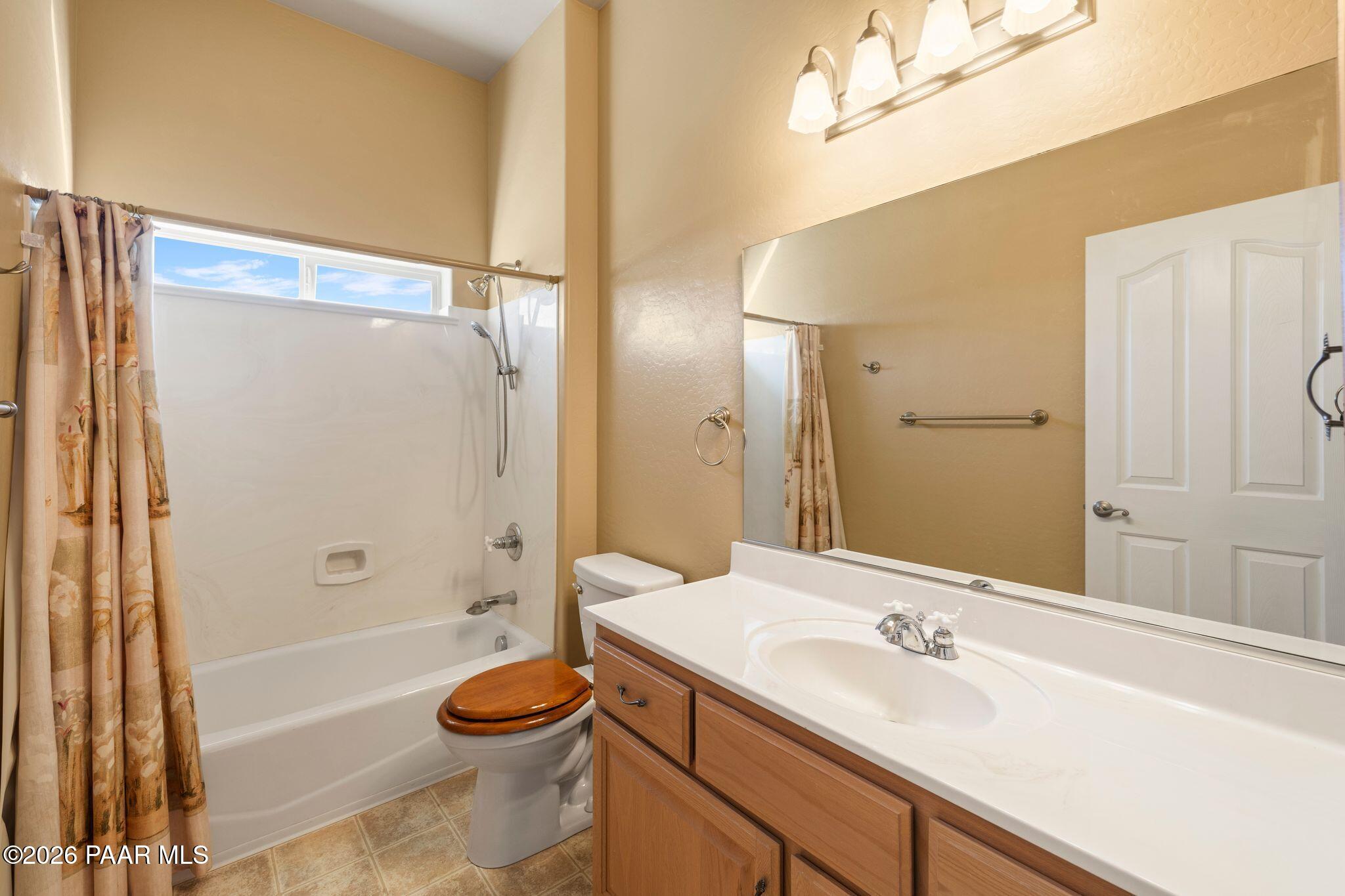 4677 Sharp Shooter Way Prescott, AZ 86301 - Photo 48 of 64 a bathroom with a granite countertop sink toilet and shower