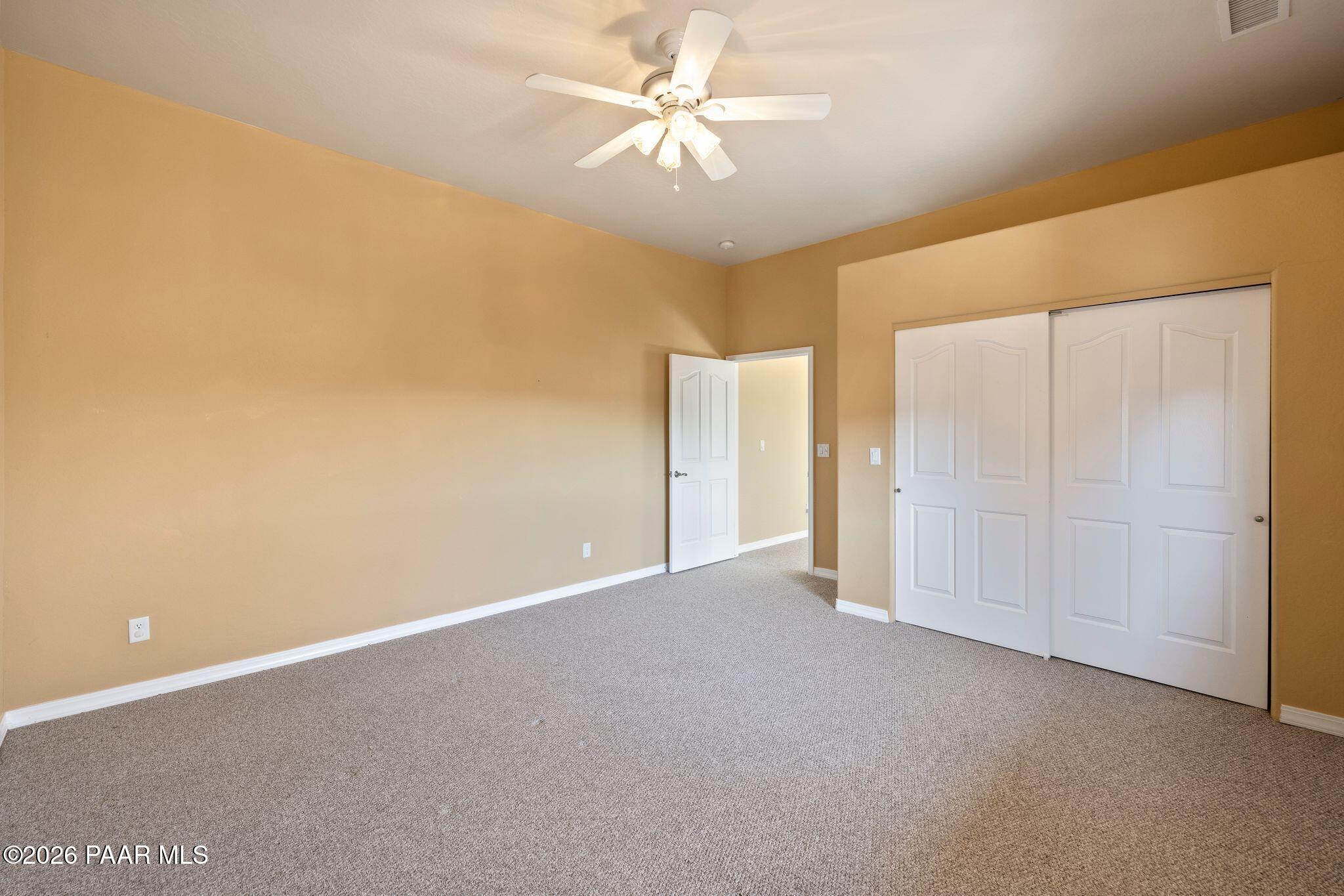 4677 Sharp Shooter Way Prescott, AZ 86301 - Photo 50 of 64 a view of an empty room with a ceiling fan