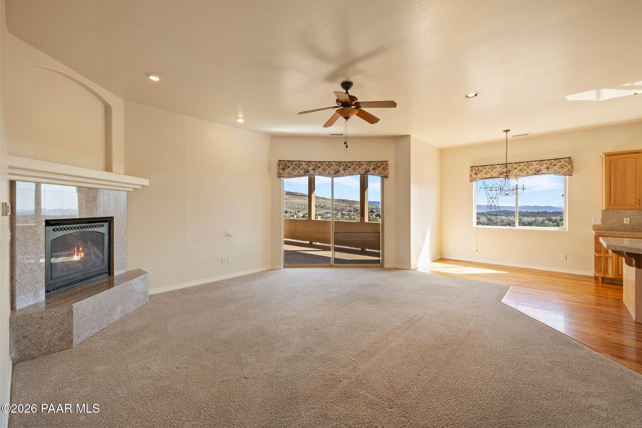 4677 Sharp Shooter Way Prescott, AZ 86301 - Photo 6 of 64 an empty room with windows and fireplace