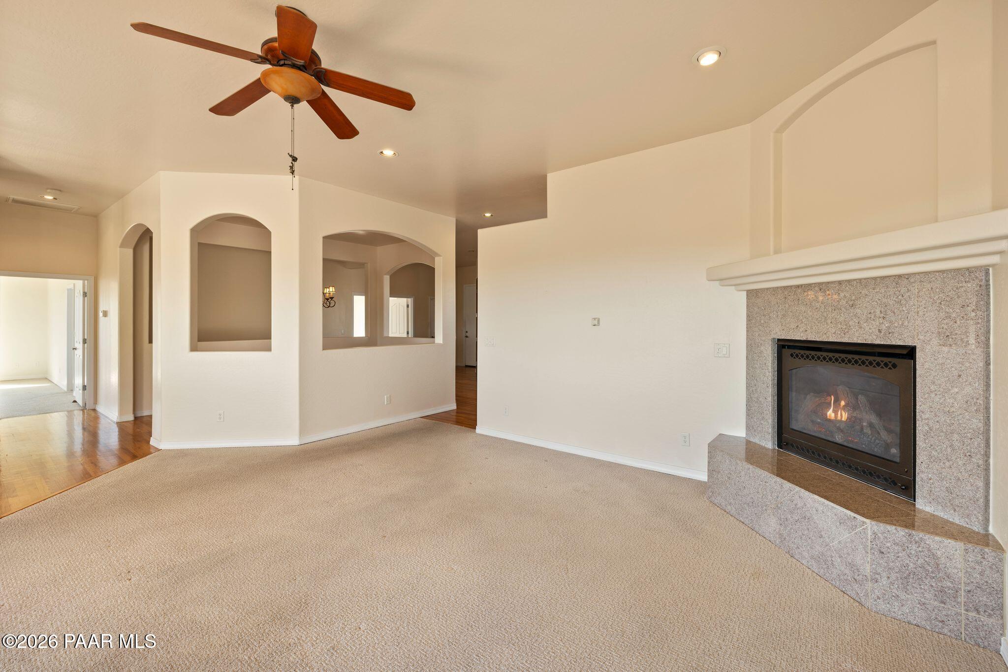 4677 Sharp Shooter Way Prescott, AZ 86301 - Photo 8 of 64 an empty room with windows and fireplace