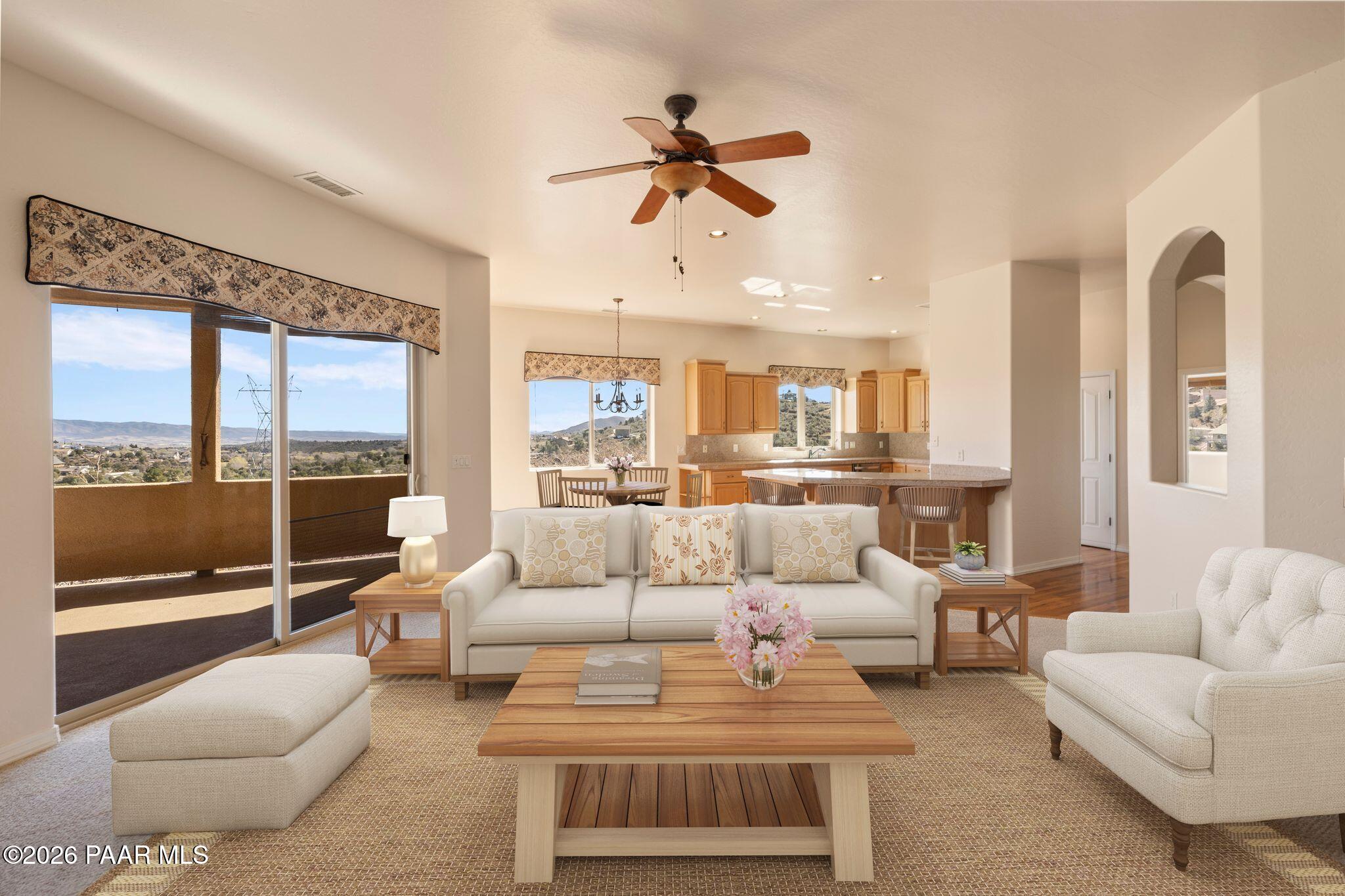 4677 Sharp Shooter Way Prescott, AZ 86301 - Photo 9 of 64 a living room with furniture ceiling fan and a large window