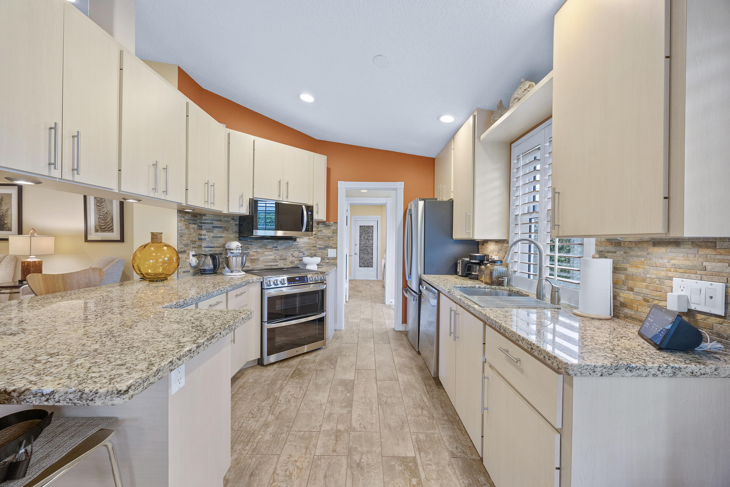 1568 Southwest Springfield Court Palm City, FL 34990 - Photo 11 of 31 a large kitchen with stainless steel appliances granite countertop a stove refrigerator and a sink