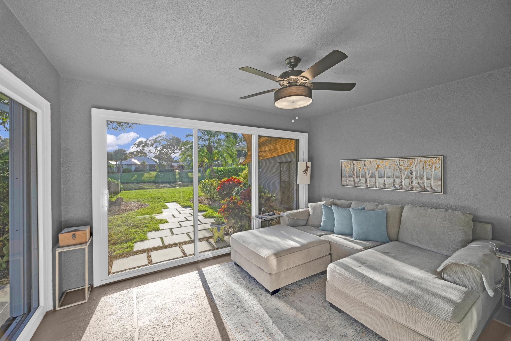 1568 Southwest Springfield Court Palm City, FL 34990 - Photo 15 of 31 a living room with furniture and a large window with garden view