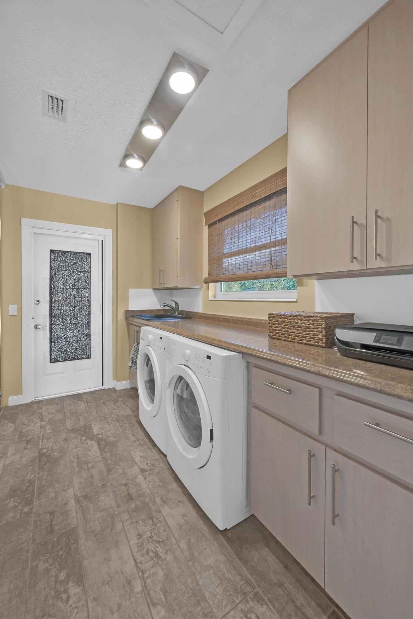 1568 Southwest Springfield Court Palm City, FL 34990 - Photo 16 of 31 a utility room with sink dryer and washer