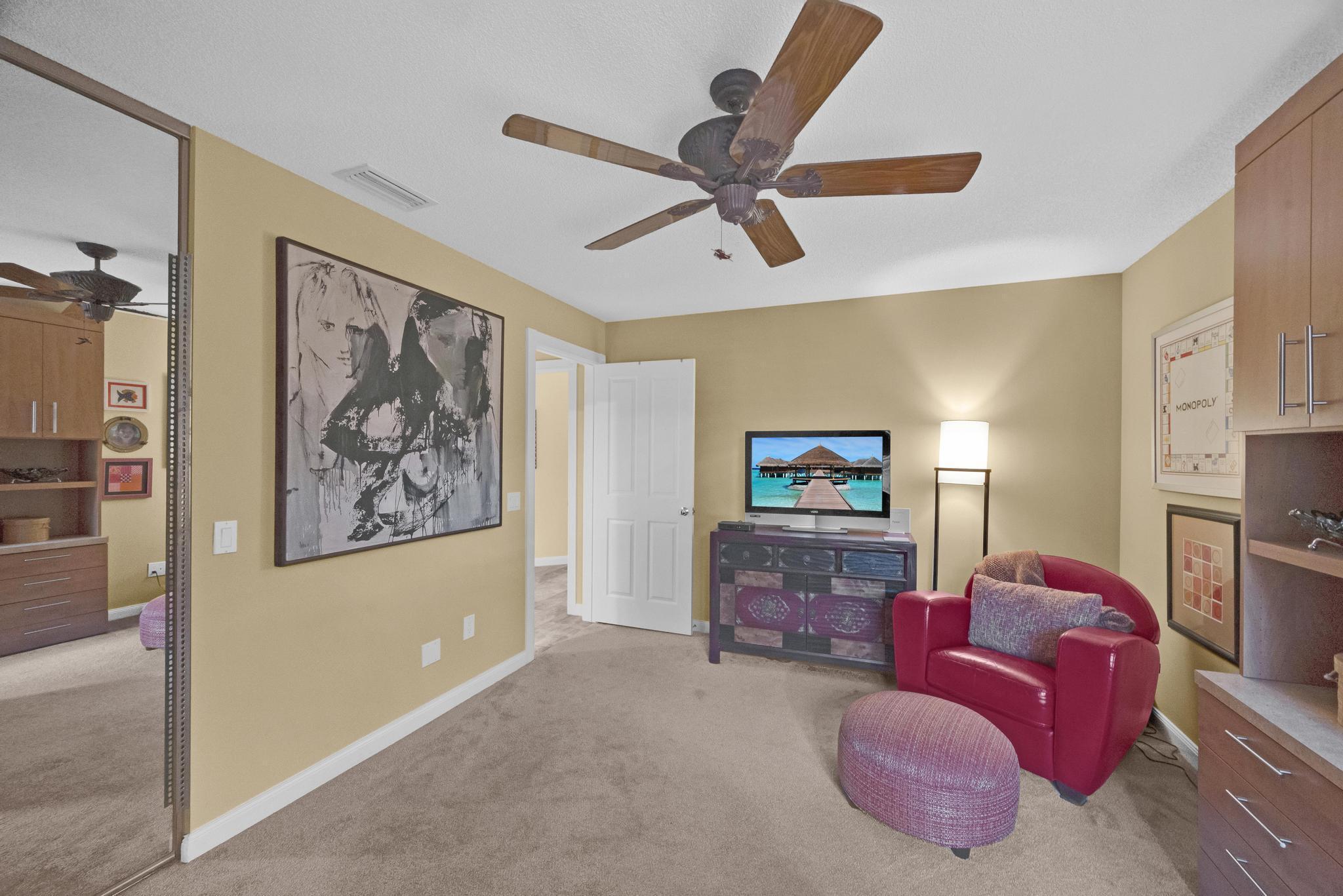 1568 Southwest Springfield Court Palm City, FL 34990 - Photo 18 of 31 a living room with furniture and a flat screen tv