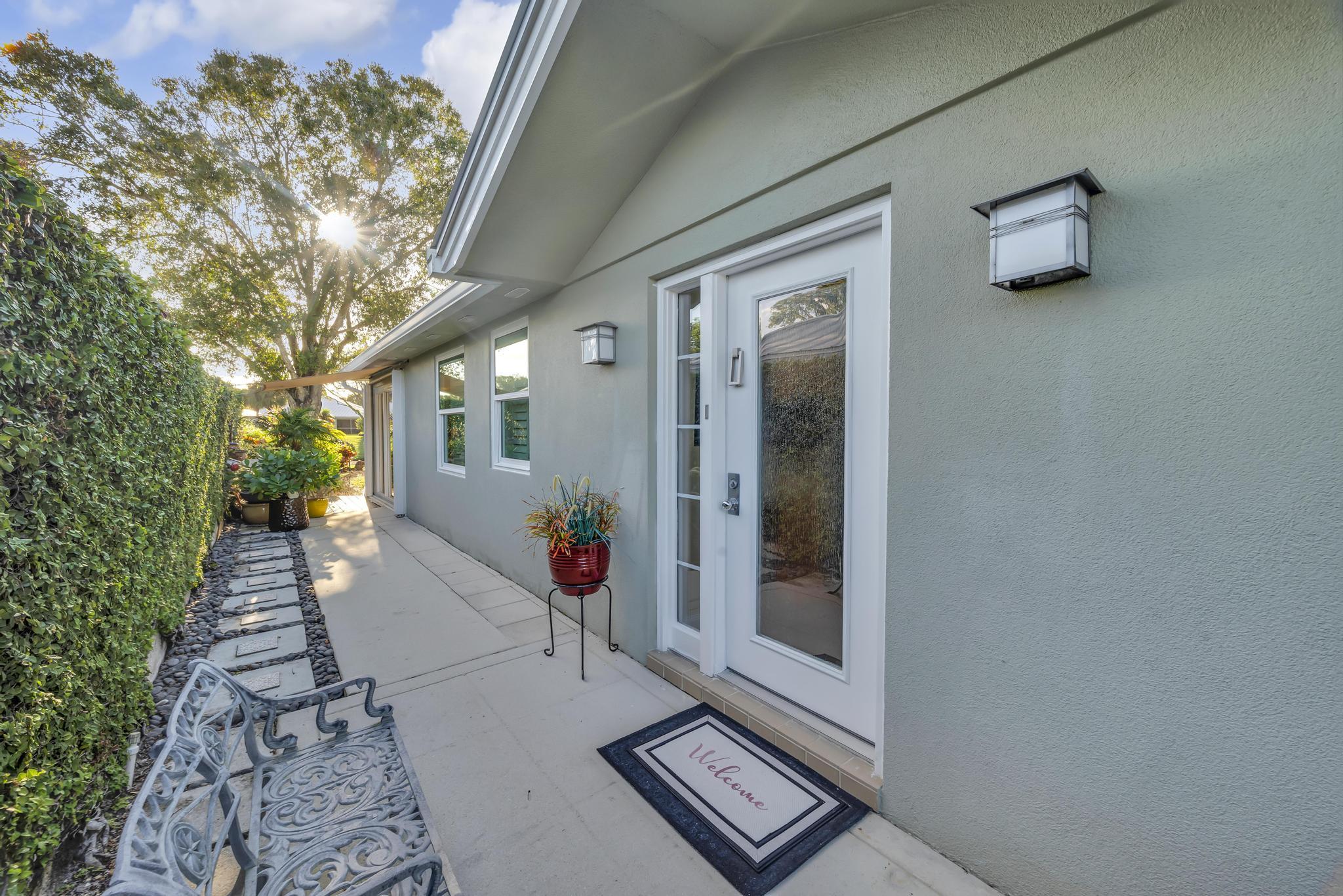 1568 Southwest Springfield Court Palm City, FL 34990 - Photo 2 of 31 a view of a front door and a yard
