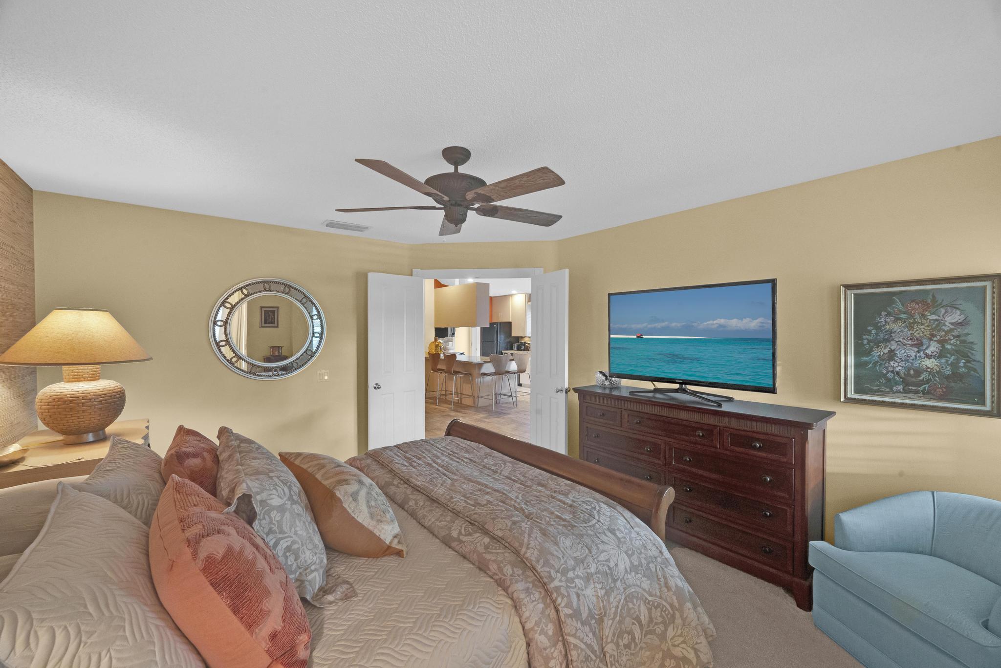 1568 Southwest Springfield Court Palm City, FL 34990 - Photo 22 of 31 a bedroom with a bed and a flat screen tv