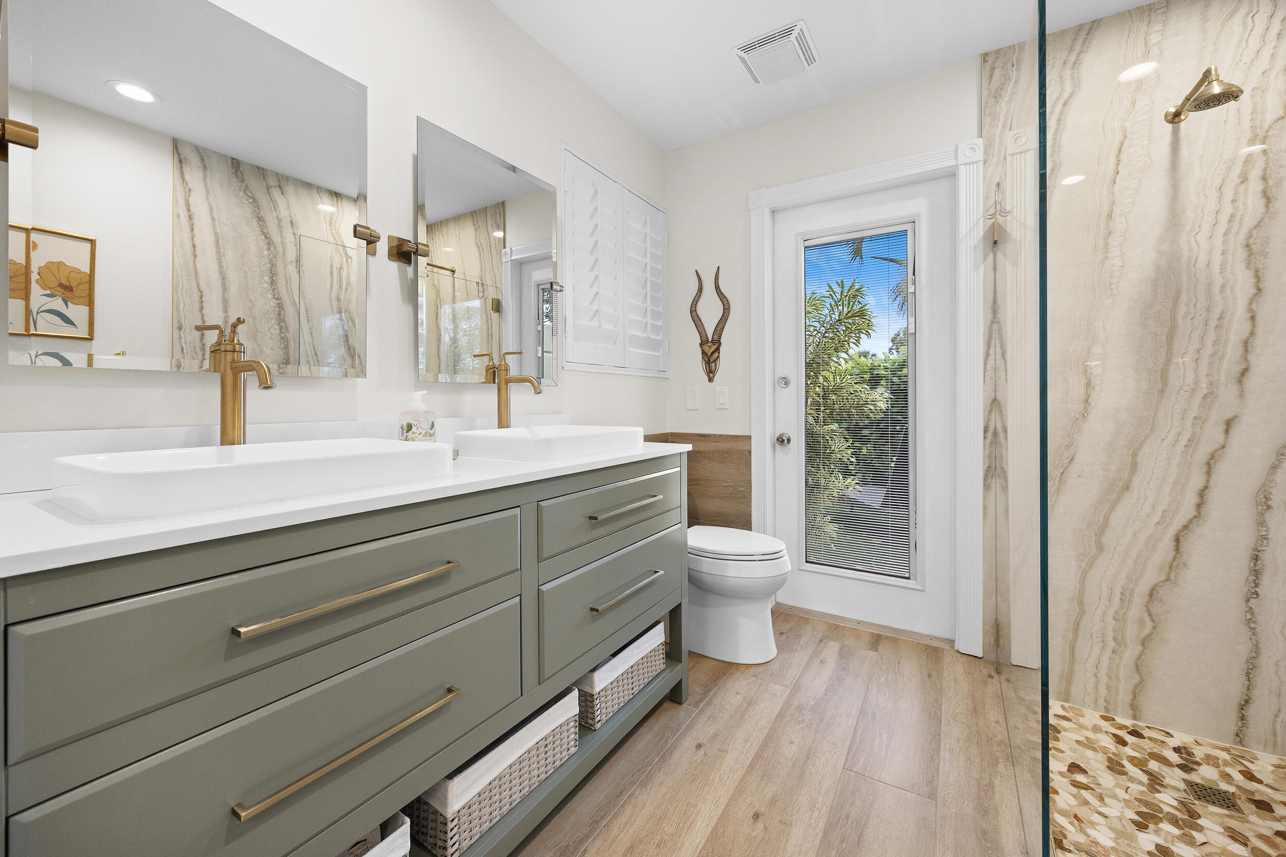 1568 Southwest Springfield Court Palm City, FL 34990 - Photo 24 of 31 a bathroom with a double vanity sink toilet and shower
