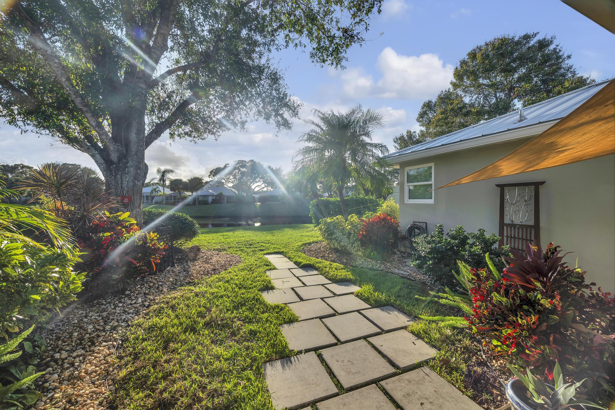 1568 Southwest Springfield Court Palm City, FL 34990 - Photo 25 of 31 a front view of a house with garden