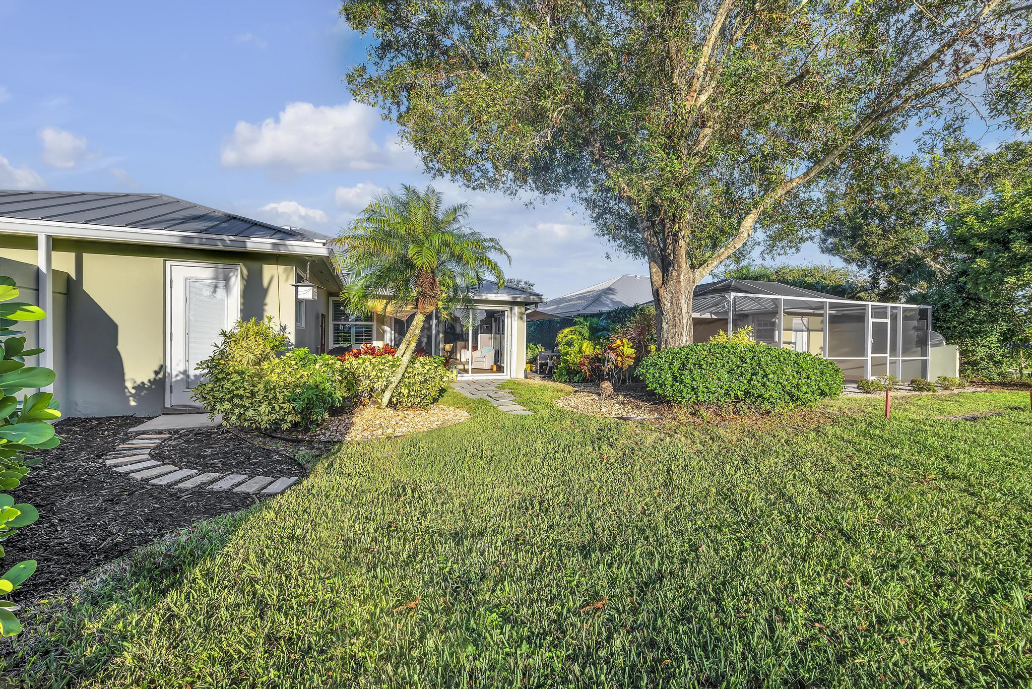 1568 Southwest Springfield Court Palm City, FL 34990 - Photo 26 of 31 a front view of a house with garden