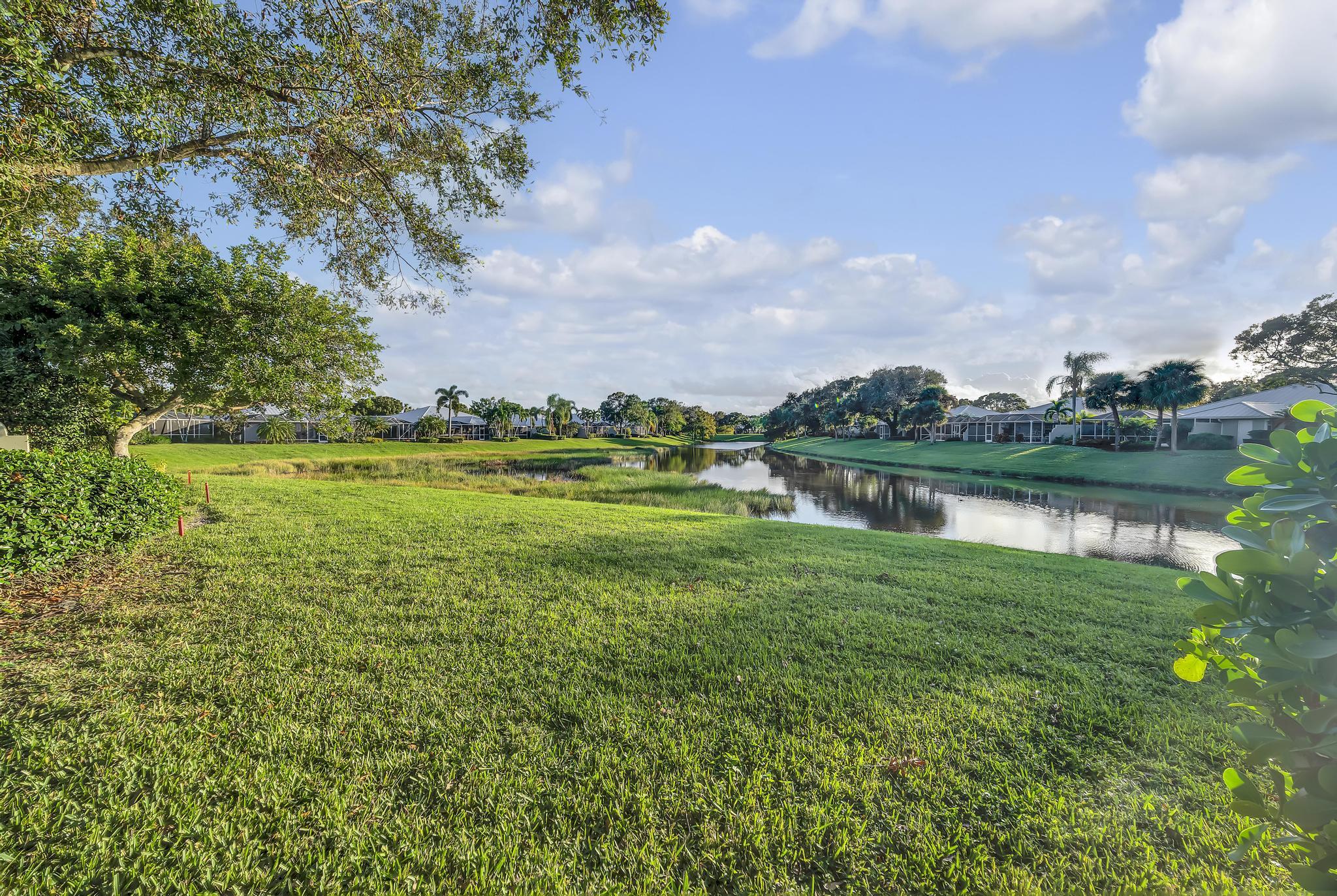1568 Southwest Springfield Court Palm City, FL 34990 - Photo 28 of 31 a view of a lake with a big yard
