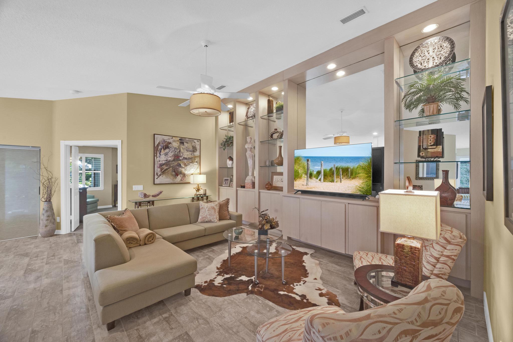 1568 Southwest Springfield Court Palm City, FL 34990 - Photo 3 of 31 a living room with furniture and a flat screen tv