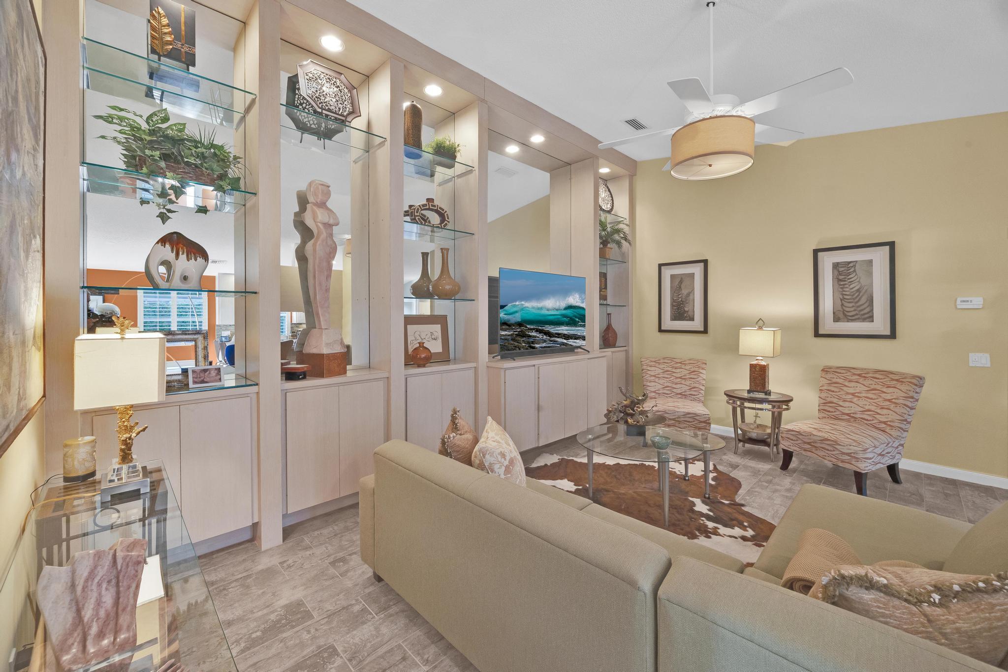1568 Southwest Springfield Court Palm City, FL 34990 - Photo 7 of 31 a living room with furniture and a chandelier