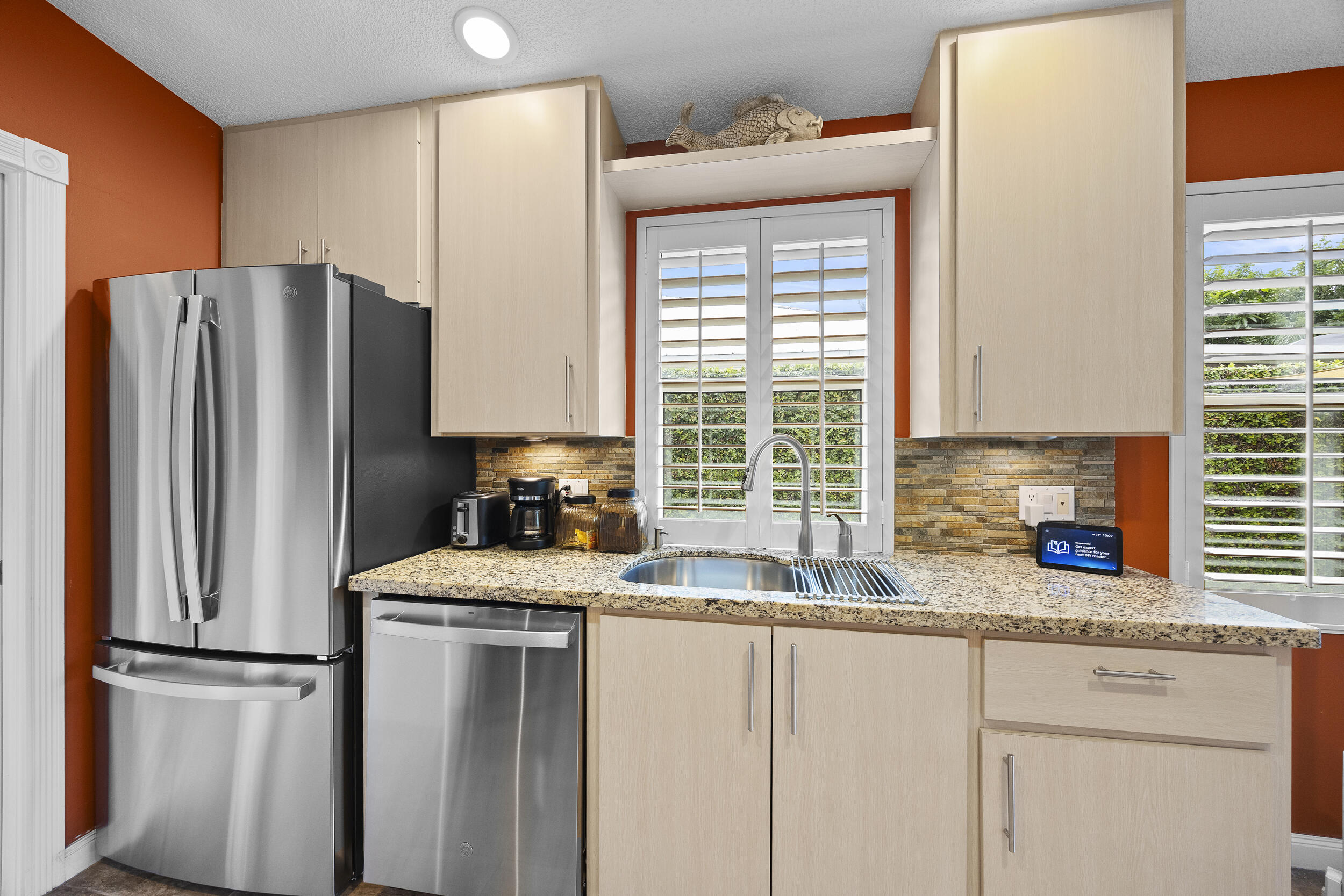 1568 Southwest Springfield Court Palm City, FL 34990 - Photo 10 of 31 a kitchen with stainless steel appliances granite countertop a refrigerator sink and cabinets