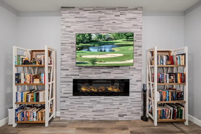 a bedroom with a bed and a flat tv screen on dresser