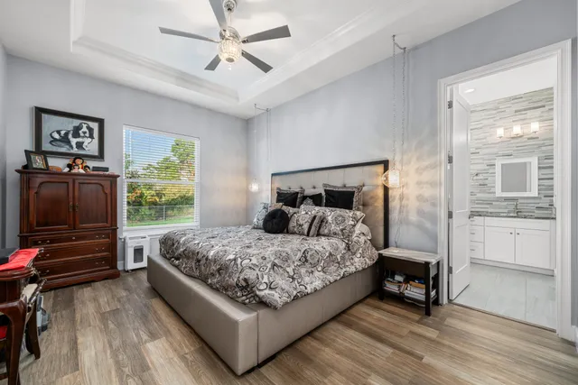 a bedroom with a bed and a chandelier