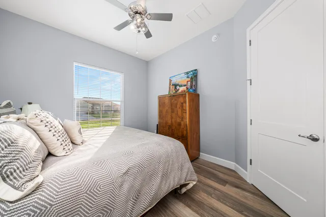 a bathroom with a granite countertop sink a toilet and shower