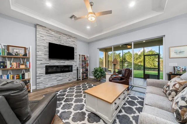 a living room with furniture a flat screen tv and a fireplace
