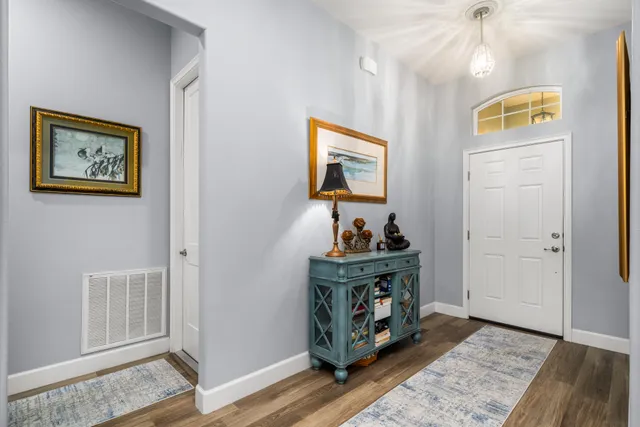 a view of a house with a yard and potted plants