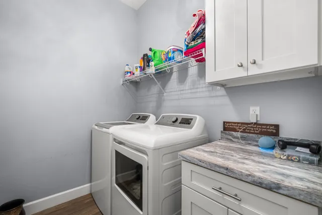 a view of a house with a potted plant and floor to ceiling window and potted plants