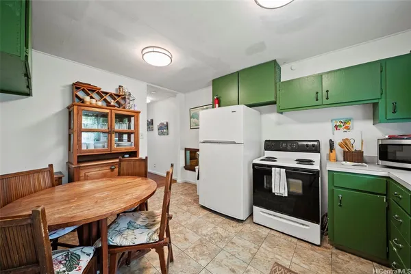 a kitchen with refrigerator and cabinets