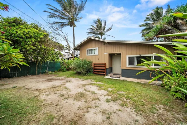 a house that has a tree in front of it