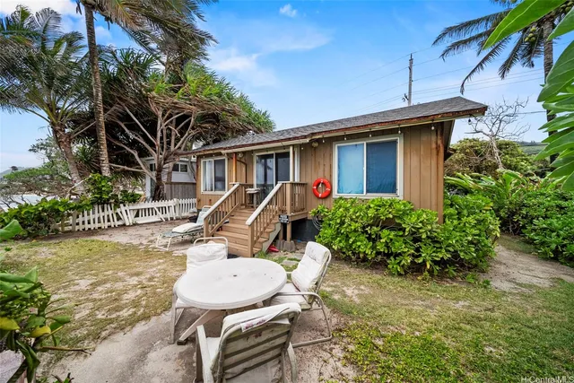 a view of a backyard with plants and a patio