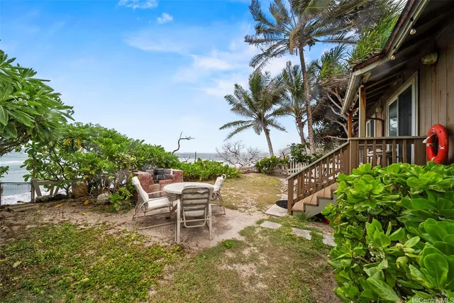 a couple of lawn chairs sitting in front of a house