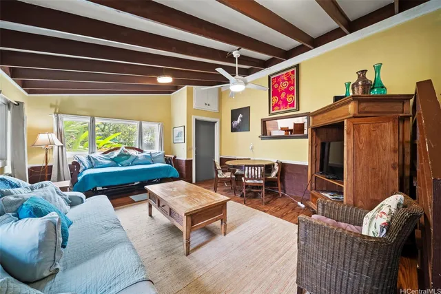 a living room with furniture and a flat screen tv