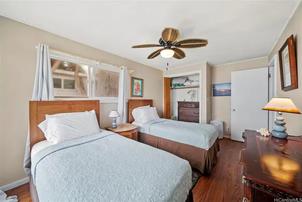 a bedroom with two beds and a chandelier