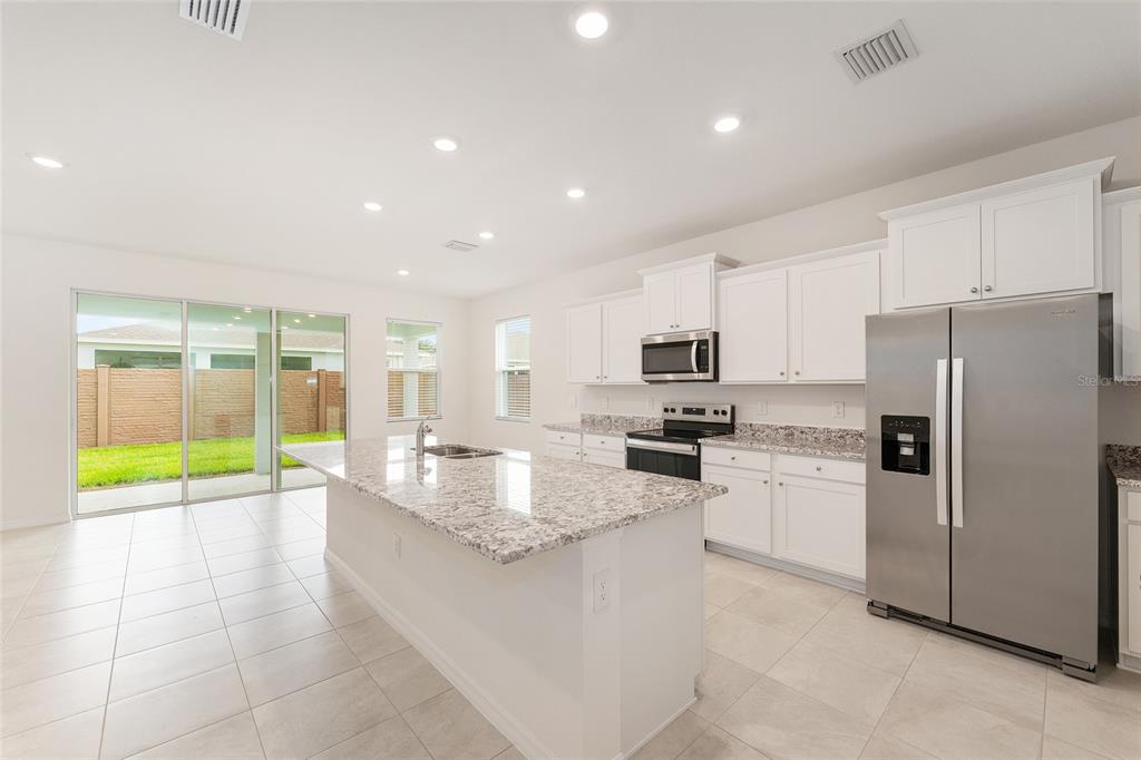 4062 Northwest 48th Terrace Ocala, FL 34482 - Photo 13 of 81 a kitchen with stainless steel appliances granite countertop a refrigerator a stove and a sink