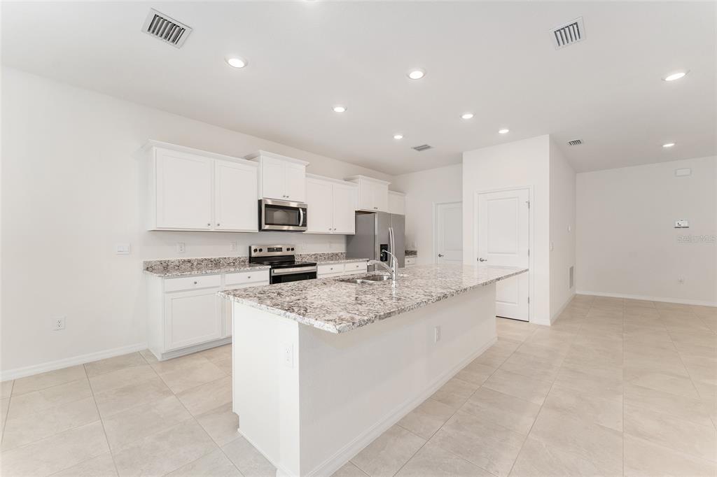 4062 Northwest 48th Terrace Ocala, FL 34482 - Photo 14 of 81 a kitchen with stainless steel appliances granite countertop a sink and cabinets