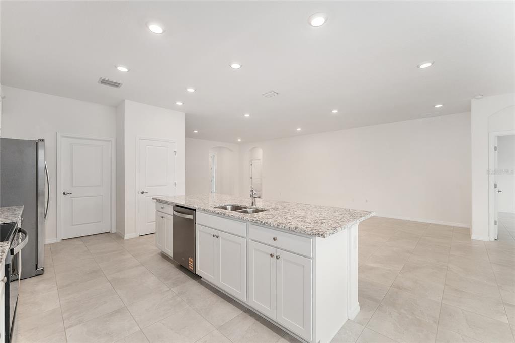 4062 Northwest 48th Terrace Ocala, FL 34482 - Photo 18 of 81 a kitchen with stainless steel appliances granite countertop a sink and white cabinets
