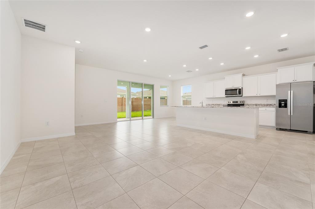 4062 Northwest 48th Terrace Ocala, FL 34482 - Photo 27 of 81 a view of a kitchen with refrigerator and windows