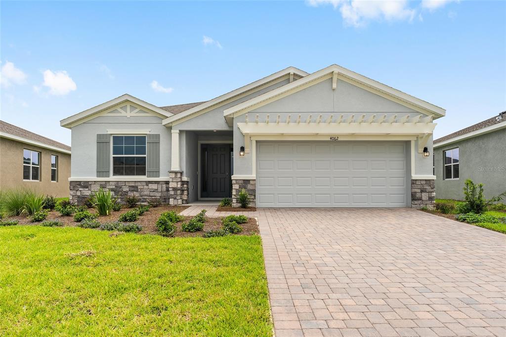 4062 Northwest 48th Terrace Ocala, FL 34482 - Photo 3 of 81 a front view of a house with garden