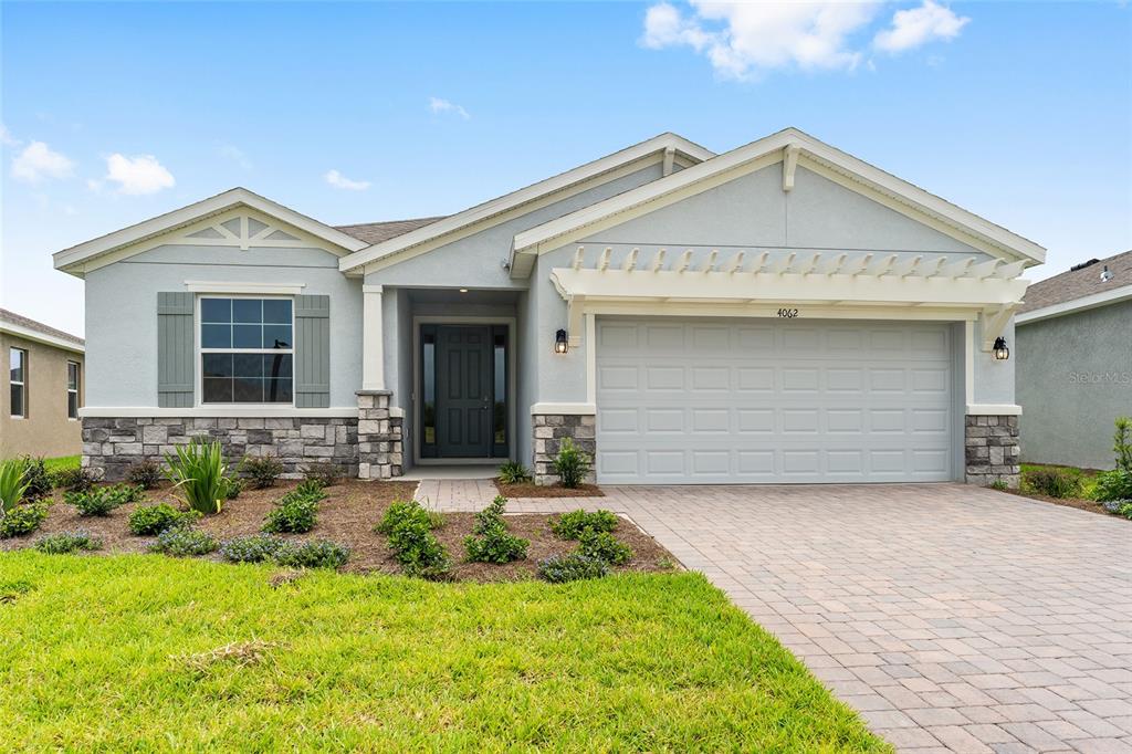 4062 Northwest 48th Terrace Ocala, FL 34482 - Photo 58 of 81 a front view of a house with a yard and garage