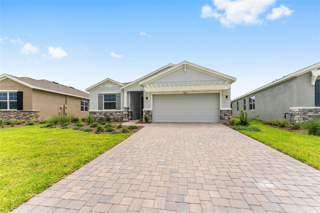 4062 Northwest 48th Terrace Ocala, FL 34482 - Photo 6 of 81 a front view of a house with garden