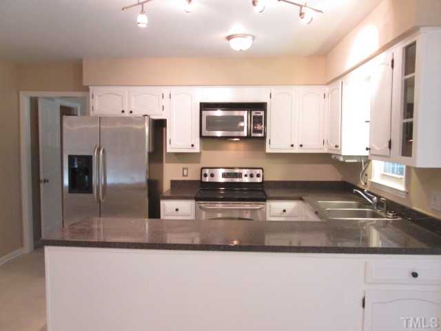 7205 St Ledger Drive Raleigh, NC 27613 - Photo 14 of 25 NEW paint and NEW lighting in the Kitchen as well as custom track lighting! refrigerator, washer and dryer stay with an acceptable offer! Smooth ceilings in the kitchen area also!
