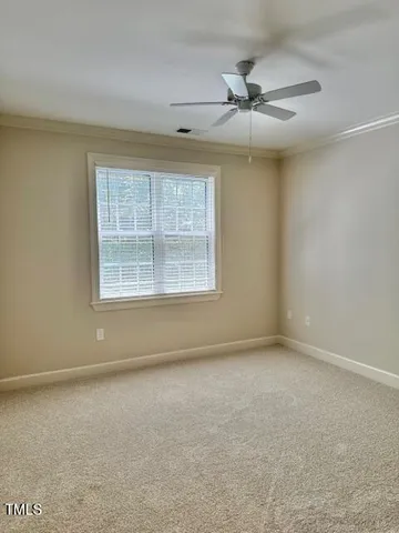 an empty room with a ceiling fan and window