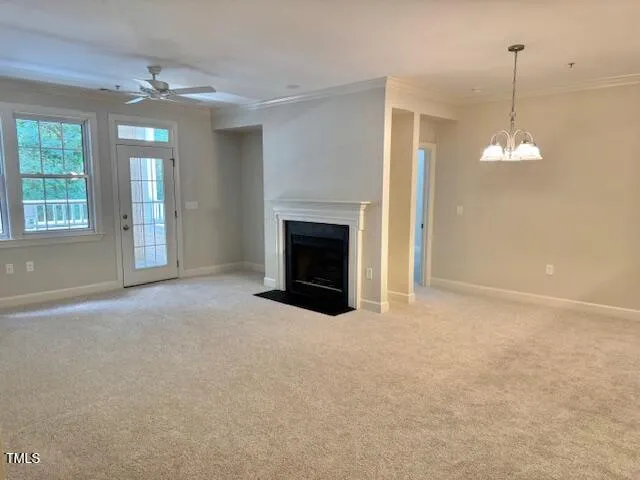 a view of an empty room with window and fireplace