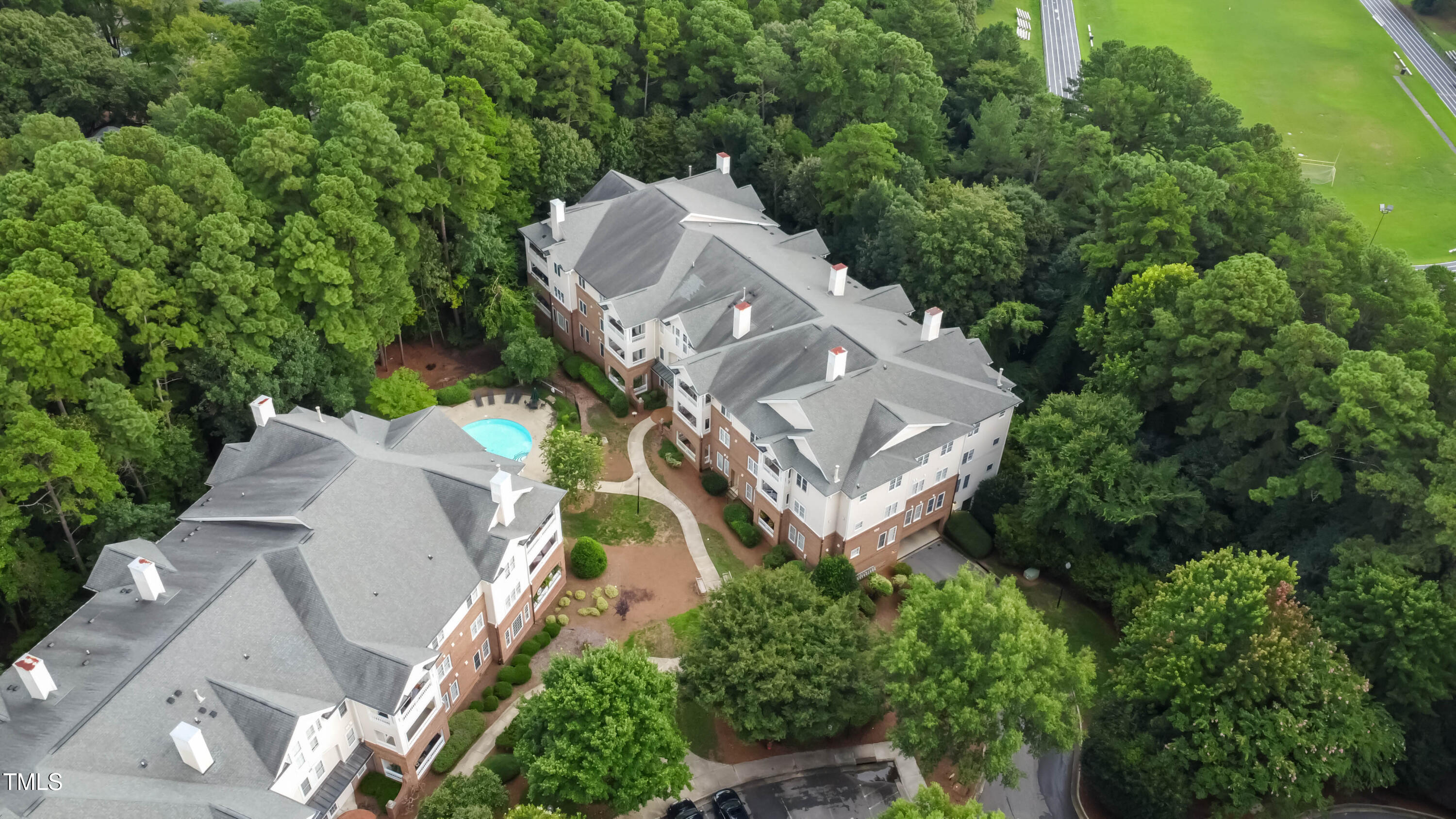 100 Northbrook Drive, Unit 205 Raleigh, NC 27609 - Photo 31 of 34 an aerial view of a house with a yard and large trees