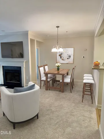 a view of a dining room with furniture and chandelier