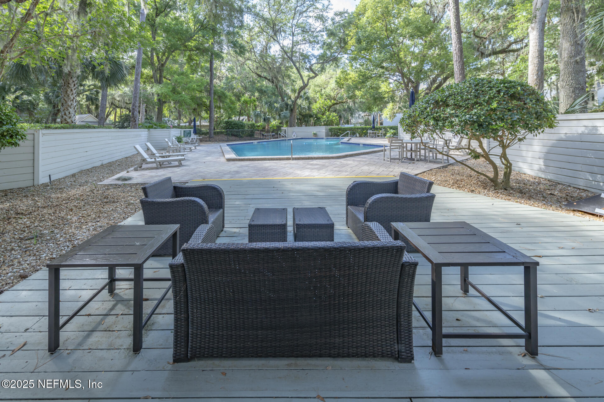 3426 Sea Marsh Road Fernandina Beach, FL 32034 - Photo 9 of 39 a view of a patio with table and chairs with wooden floor and fence