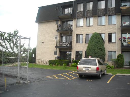 7301 Willow Springs Road, Unit 207 Countryside, IL 60525 - Photo 1 of 1 a car parked in front of a brick house
