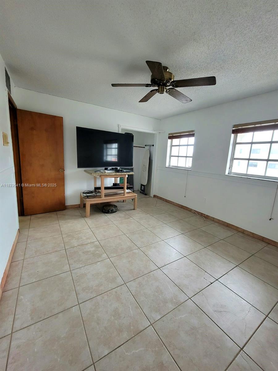 11 Olive Drive, Unit J Hialeah, FL 33010 - Photo 11 of 20 a living room with furniture and a flat screen tv