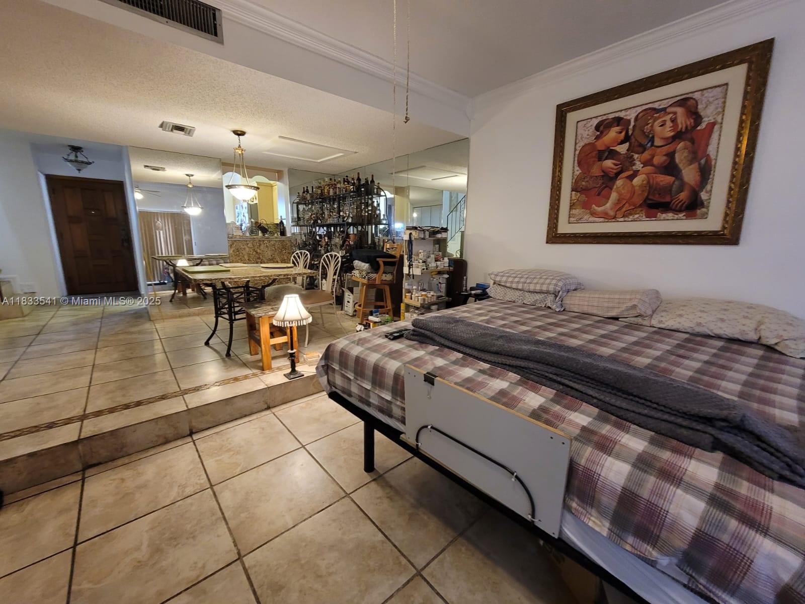 11 Olive Drive, Unit J Hialeah, FL 33010 - Photo 15 of 20 a living room with furniture a dining table and kitchen view