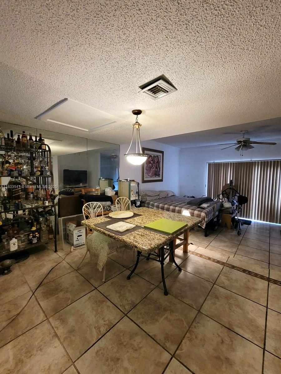 11 Olive Drive, Unit J Hialeah, FL 33010 - Photo 16 of 20 a living room with lots of furniture and a table