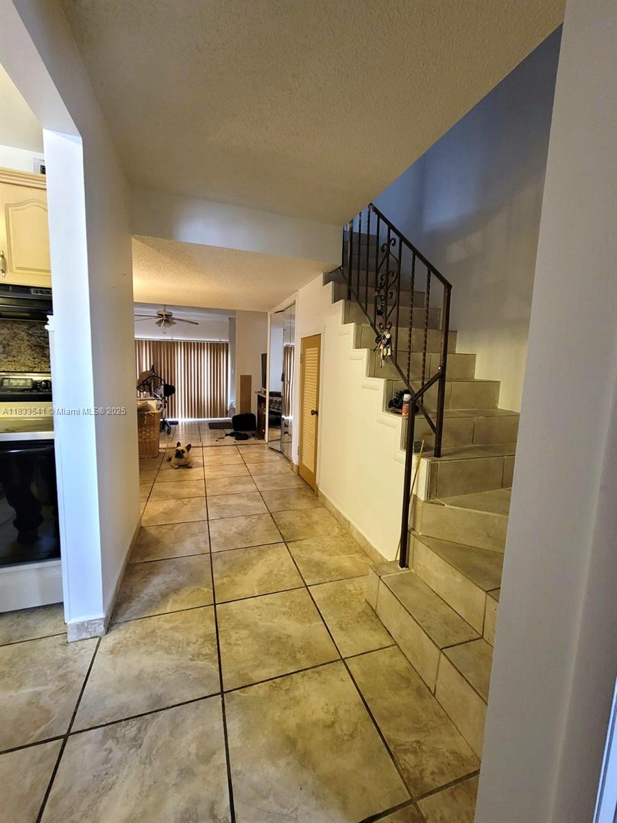 11 Olive Drive, Unit J Hialeah, FL 33010 - Photo 3 of 20 a hallway with a dining table and a mirror