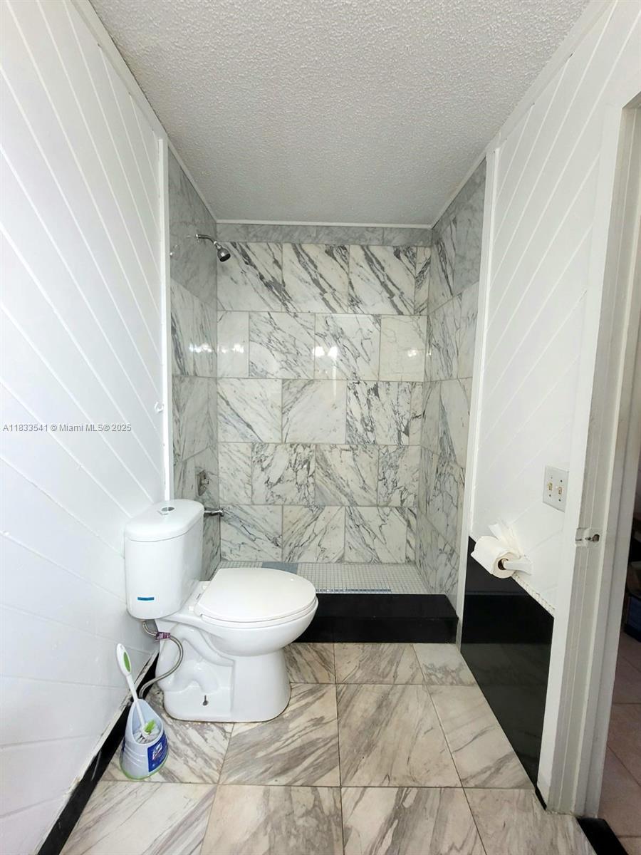 11 Olive Drive, Unit J Hialeah, FL 33010 - Photo 7 of 20 a bathroom with a toilet and a shower