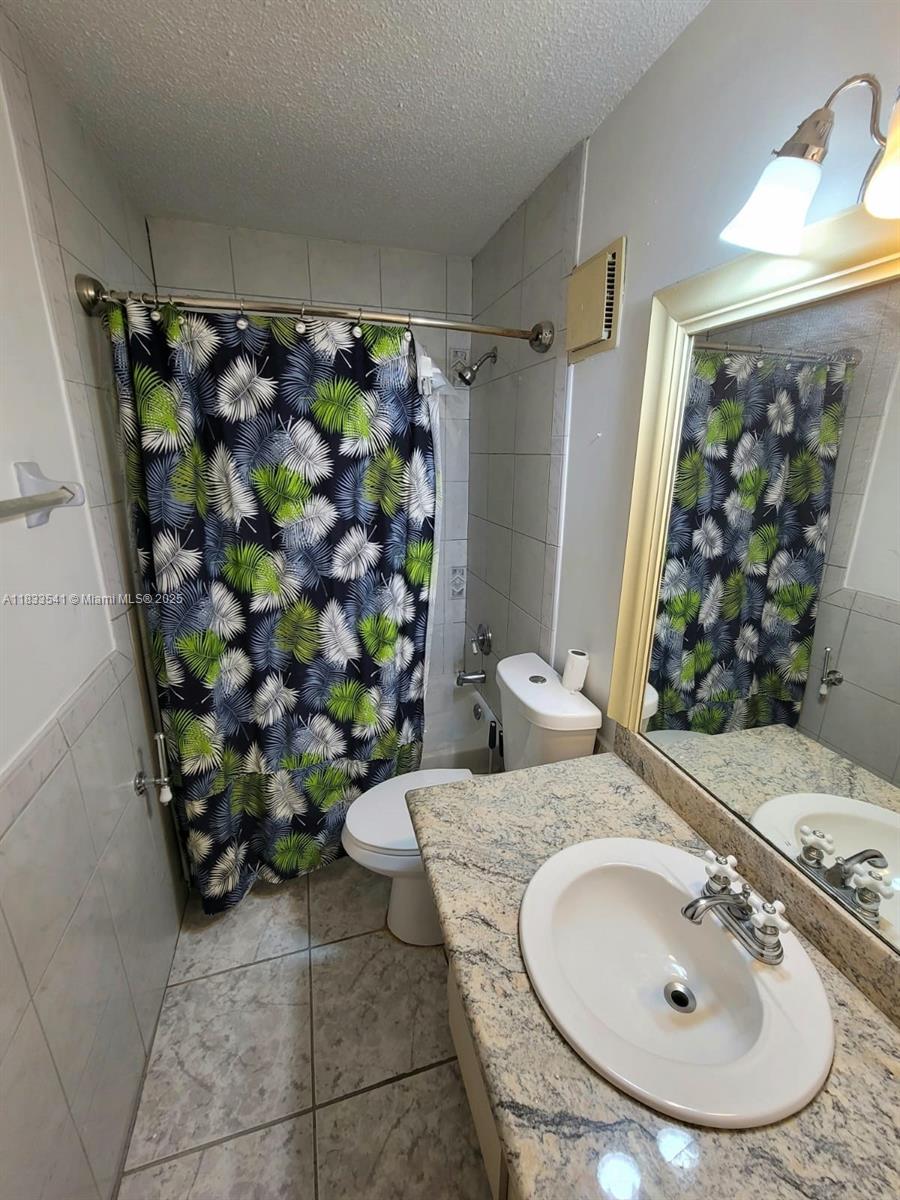 11 Olive Drive, Unit J Hialeah, FL 33010 - Photo 8 of 20 a bathroom with a sink toilet and shower